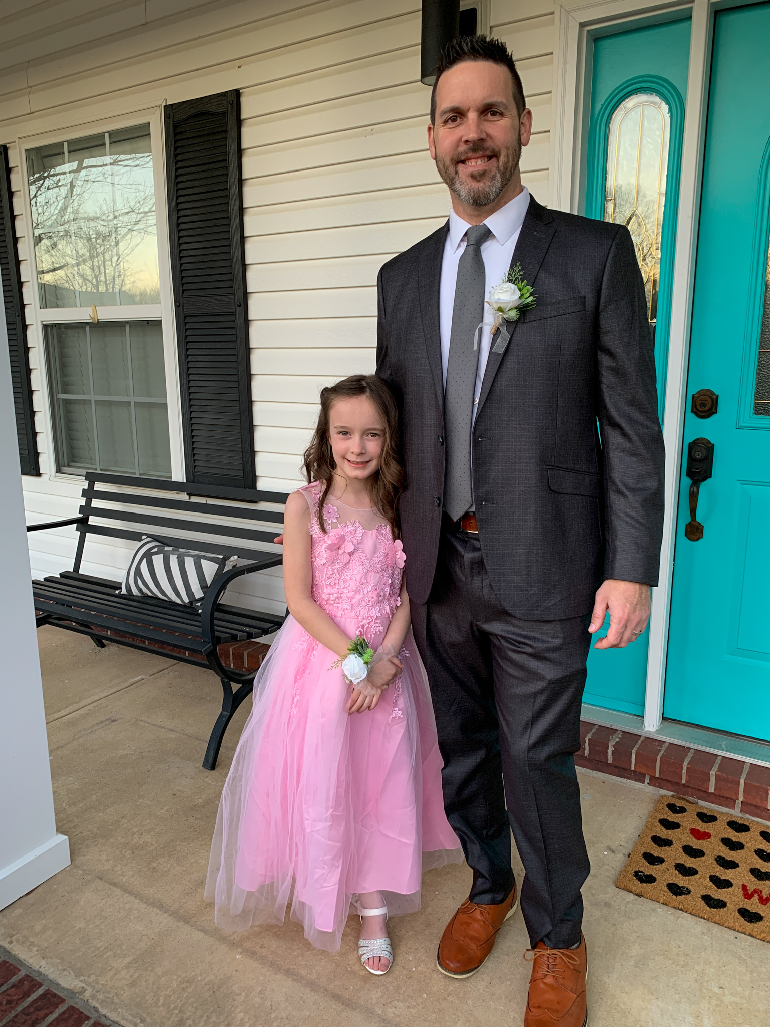 little girl standing with Daddy in Daddy Daughter outfits and faux corsage and boutonniere