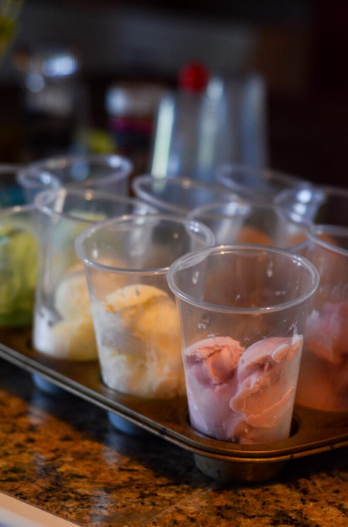 pretty ice cream scoops in clear plastic cups on metal tray