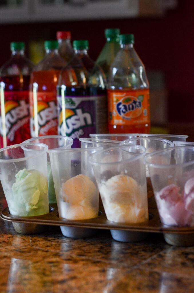ice cream in plastic cups on a metal tray for an ice cream float party