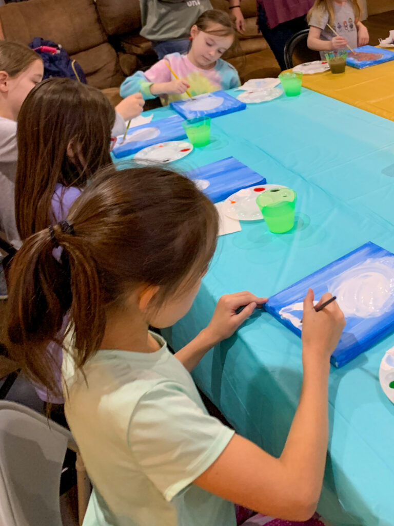 girls starting a snowman on a snowman paint night