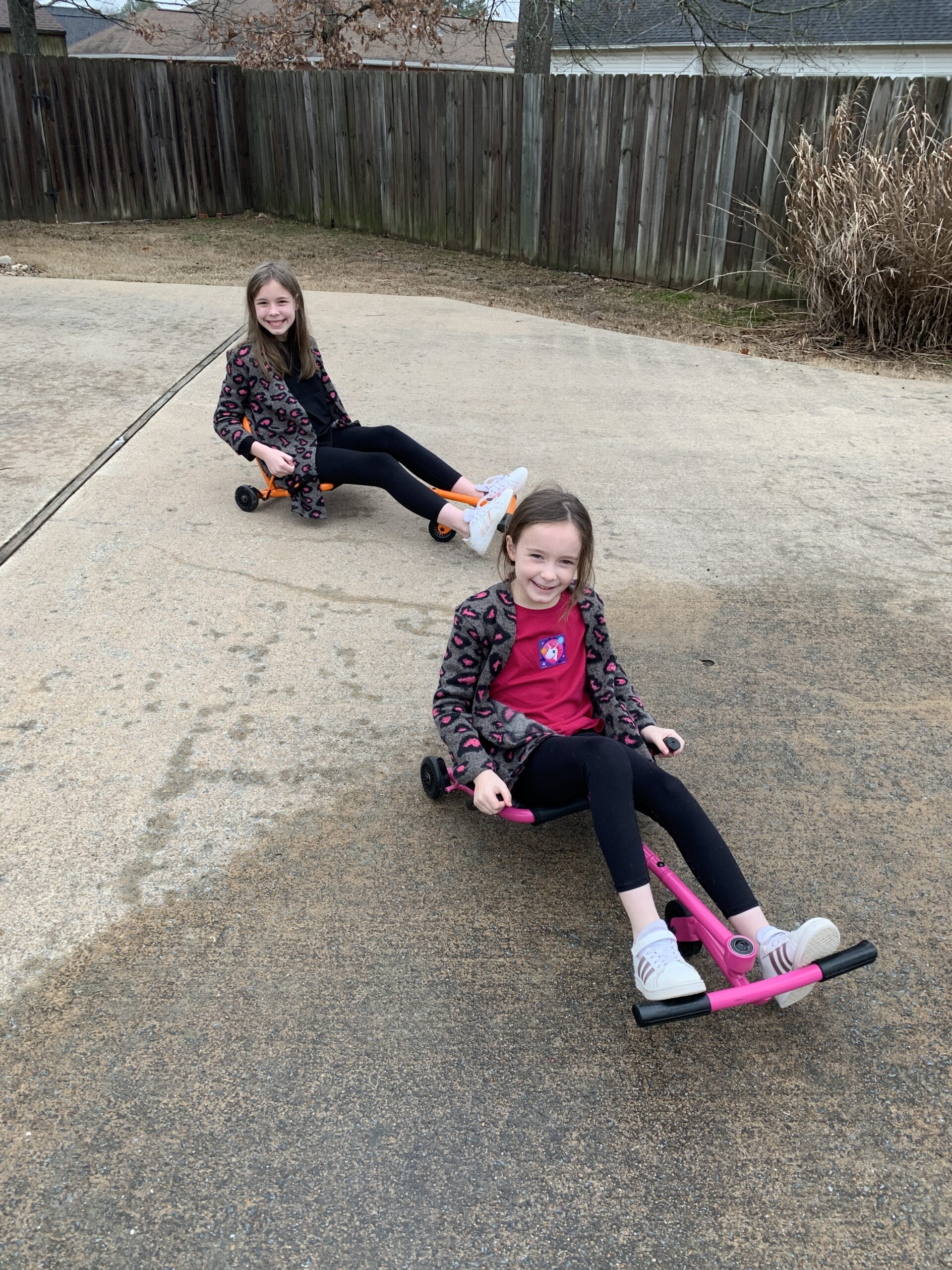 girls on EZ Rollers on driveway
