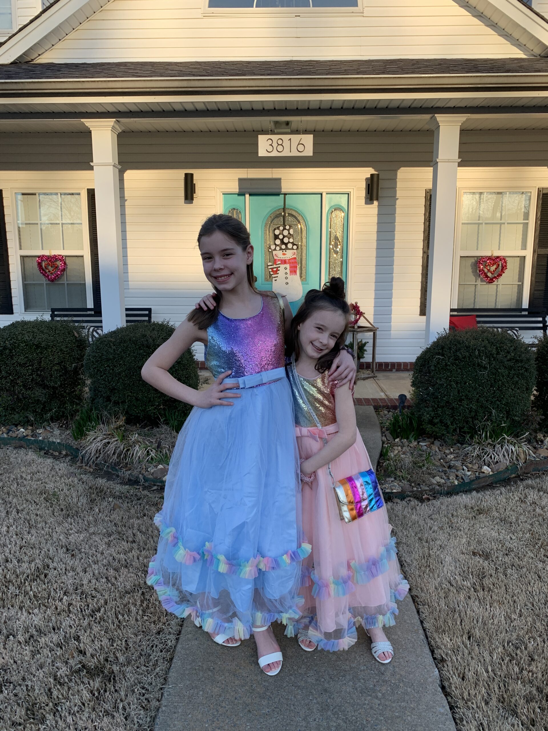 two tween bloggers pose in party dresses