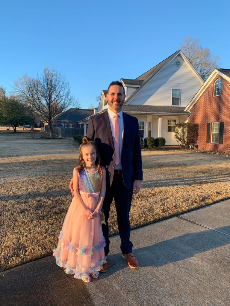 little girl in rainbow party dress with her daddy for Daddy Daughter Dance outfit