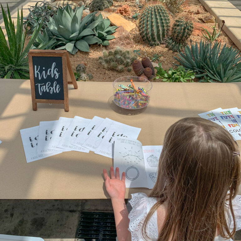 little girl looking at things for kids to do at a wedding at Will Rogers gardens in OKC