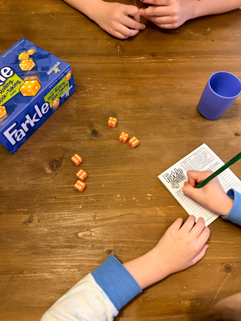 two kids playing Farkle for family dice games night