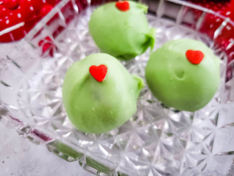 Grinch Oreo balls on small glass platter