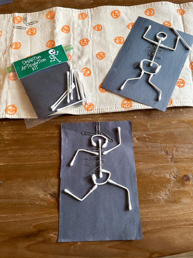 Halloween skeleton STEM activity on table with free DIY Halloween STEM kits