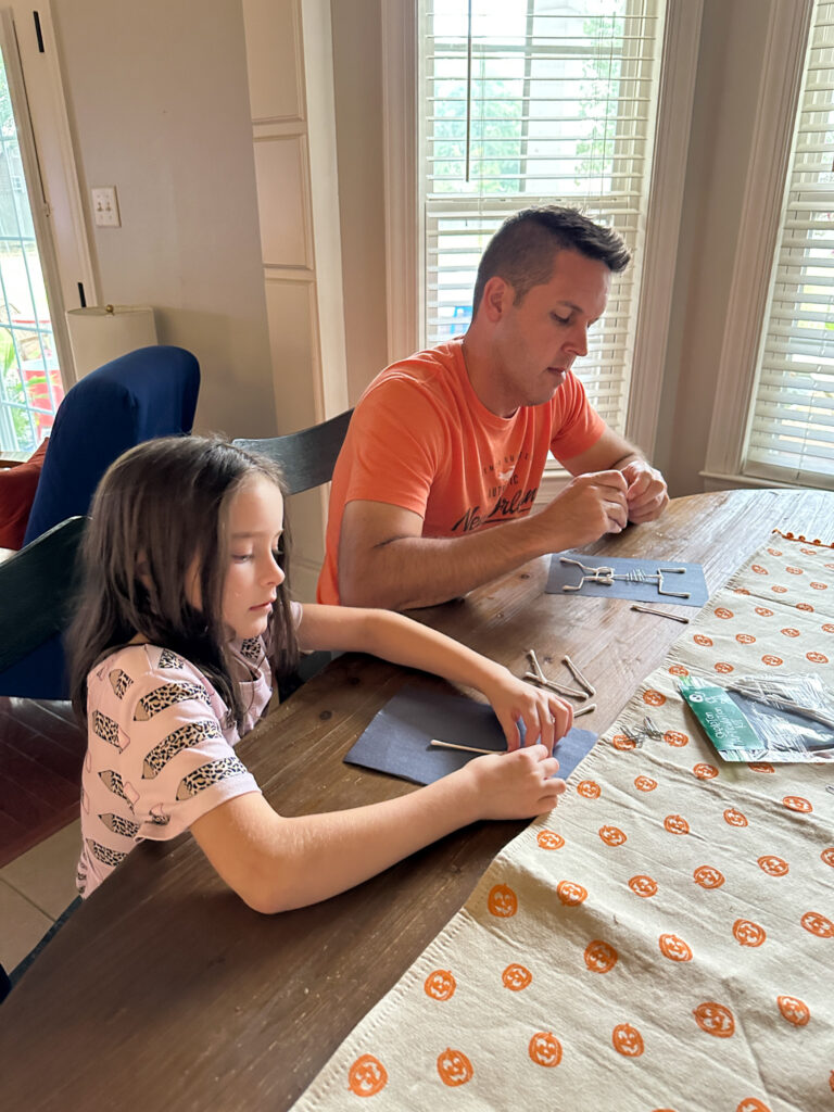 dad and girl work on craft project