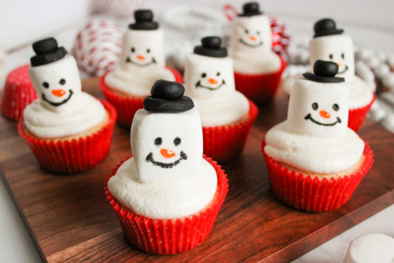 snowman cupcakes on wood tray