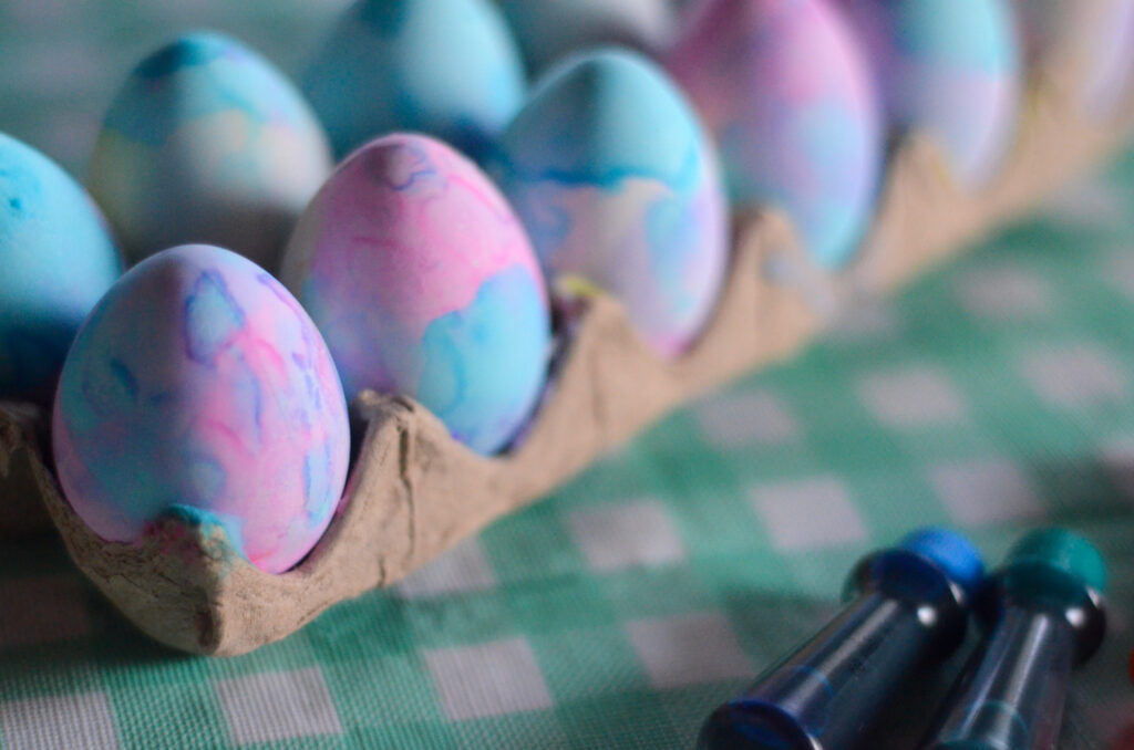 carton of food coloring Easter eggs with whipped cream