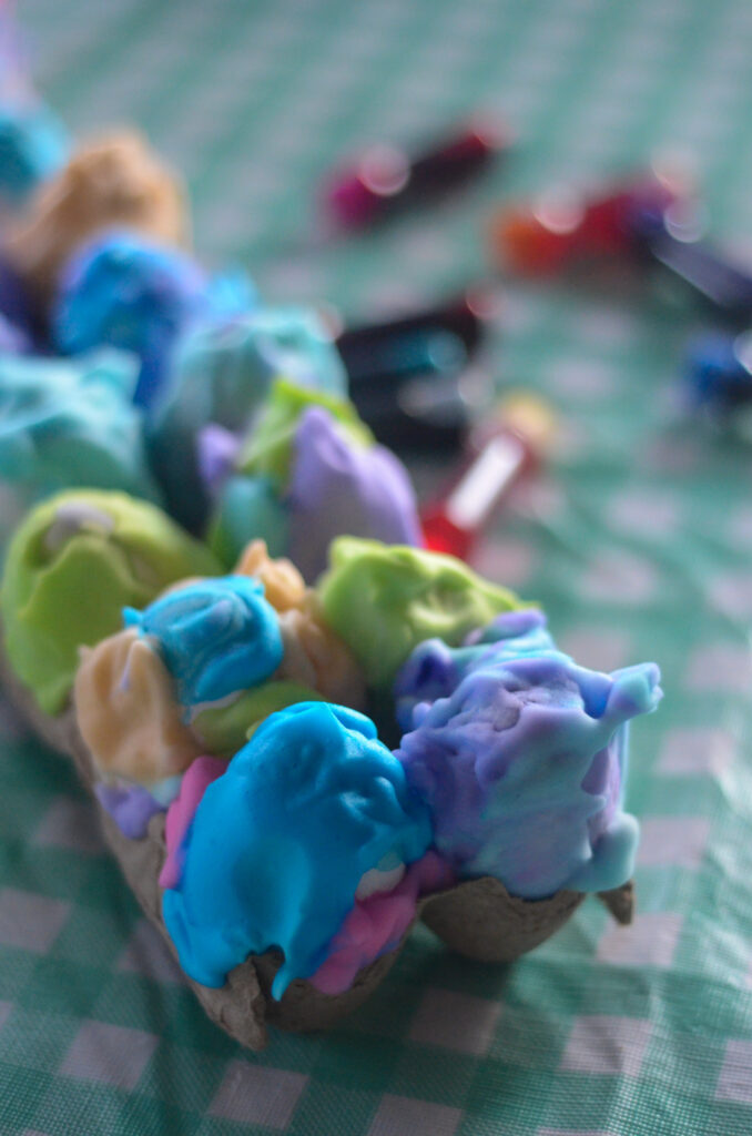 Cool Whip Easter eggs with food coloring setting up in carton