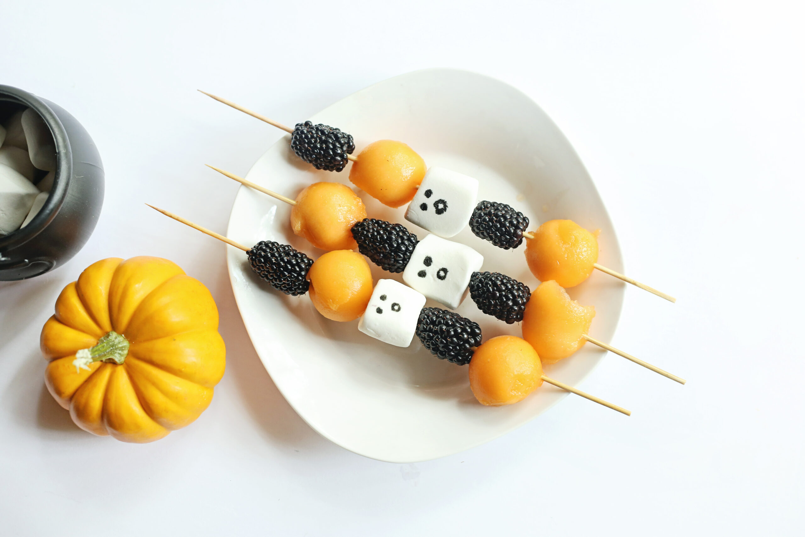 fruit ghost skewers for Halloween on white plate