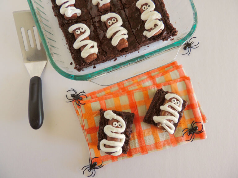 mummy brownies for Halloween on orange napkin
