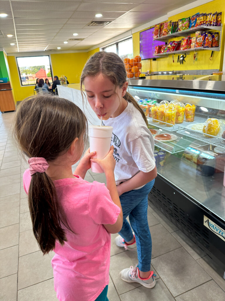 little girls sharing a horchata at Fort Smith ice cream spot - La Nueva Michoacana