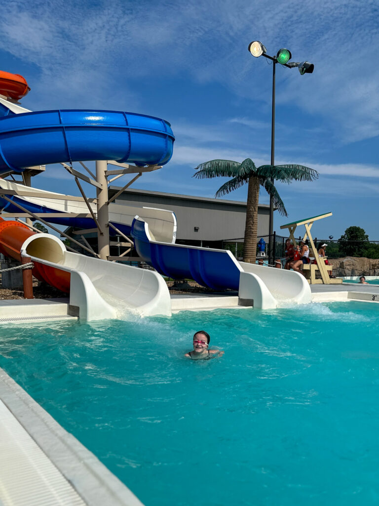 little girl coming off the water slide at Parrot Island Waterpark in Fort Smith, Arkansas