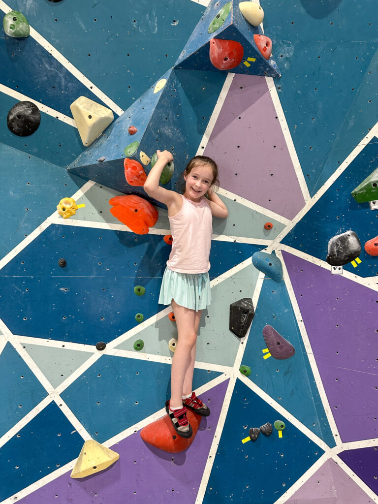 Arkansas blogger, Norah, climbing on wall at Vertical Horizons Climbing Wall in Fort Smith, Arkansas