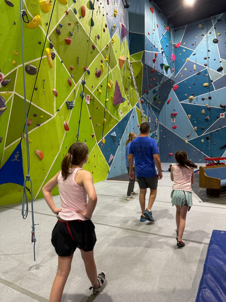 family walks around Vertical Horizons Climbing Gym in Fort Smith, Arkansas