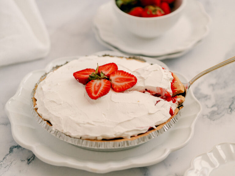strawberry pie with glaze with slice being pulled out