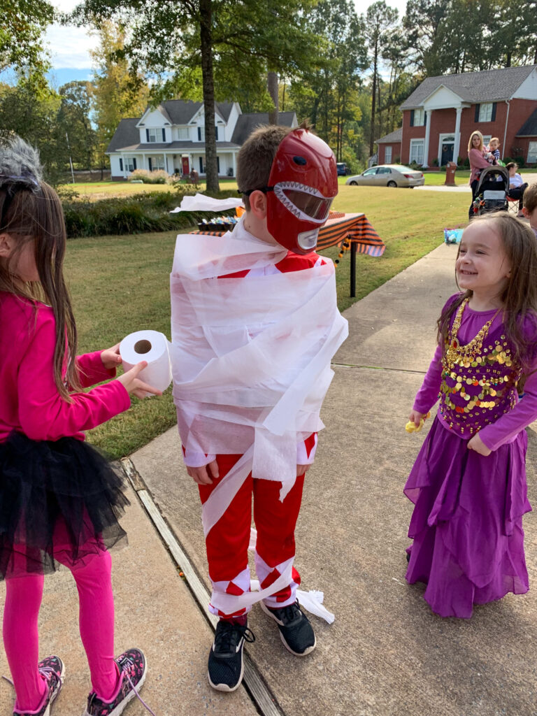 kids playing a mummy wrapping game at Halloween party for tweens and kids
