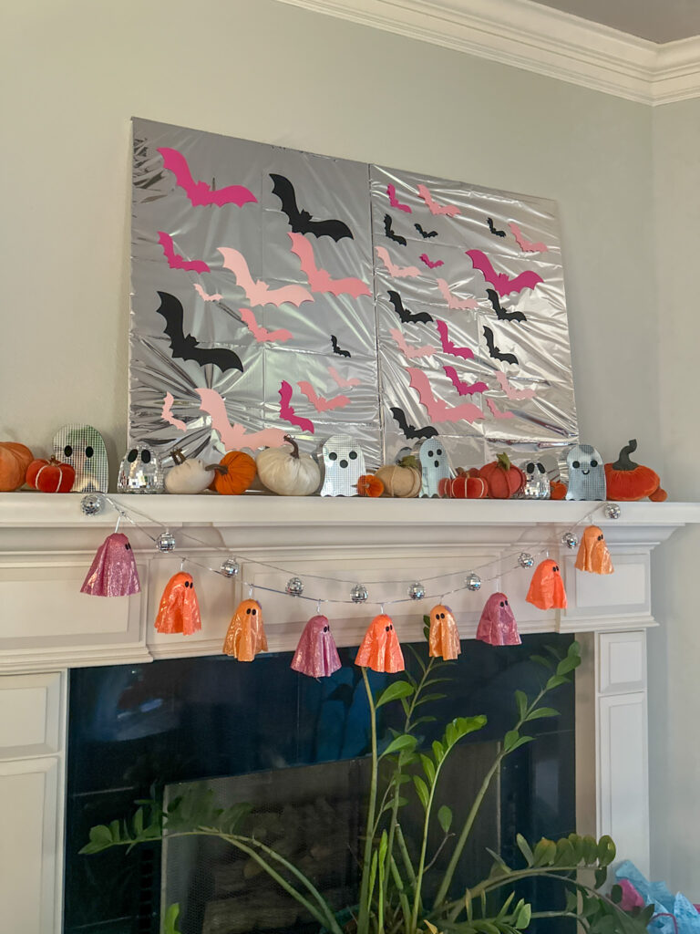 disco Halloween mantel with a DIY bat artwork above
